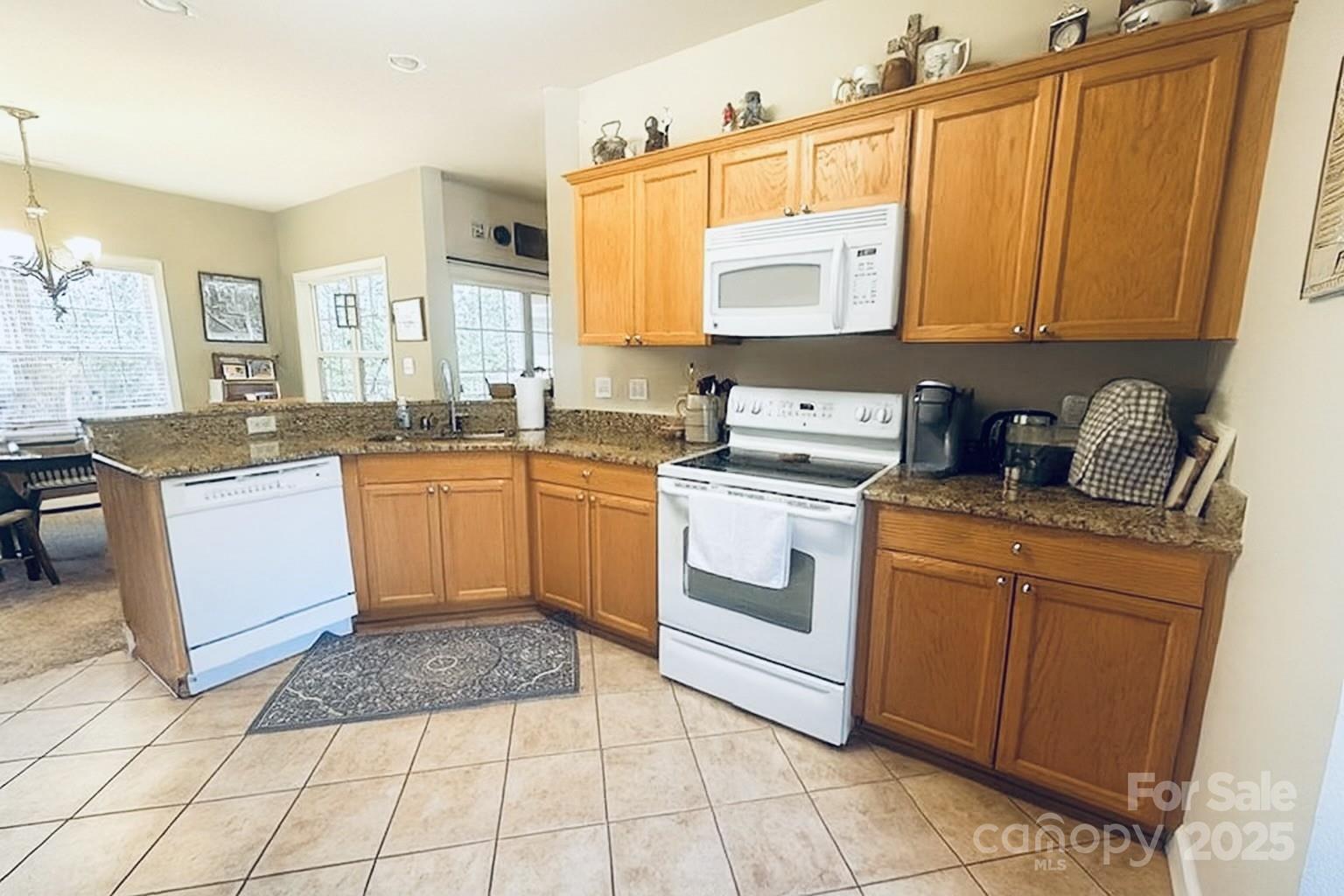 1350 21st Avenue Northeast Hickory, NC 28601 - Photo 12 of 27 a kitchen with a sink stove and cabinets