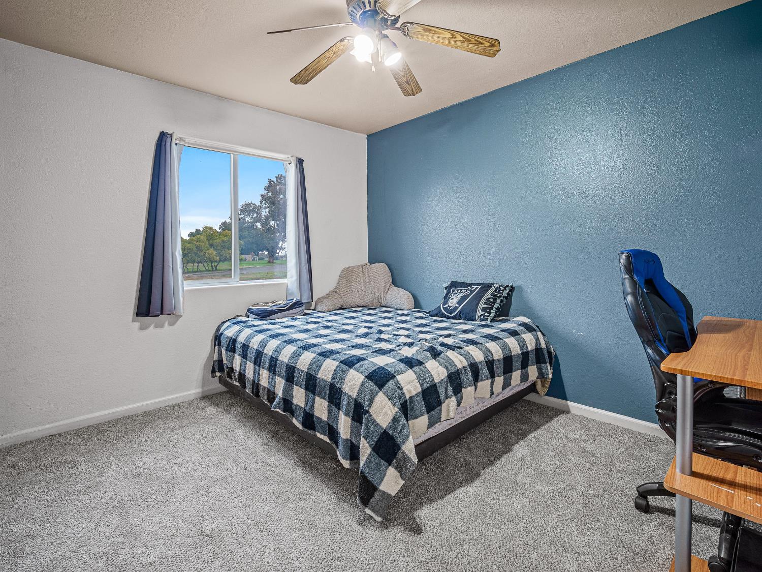 10893 Woolwich Way Mather, CA 95655 - Photo 15 of 24 a bedroom with a bed a chair and a large window