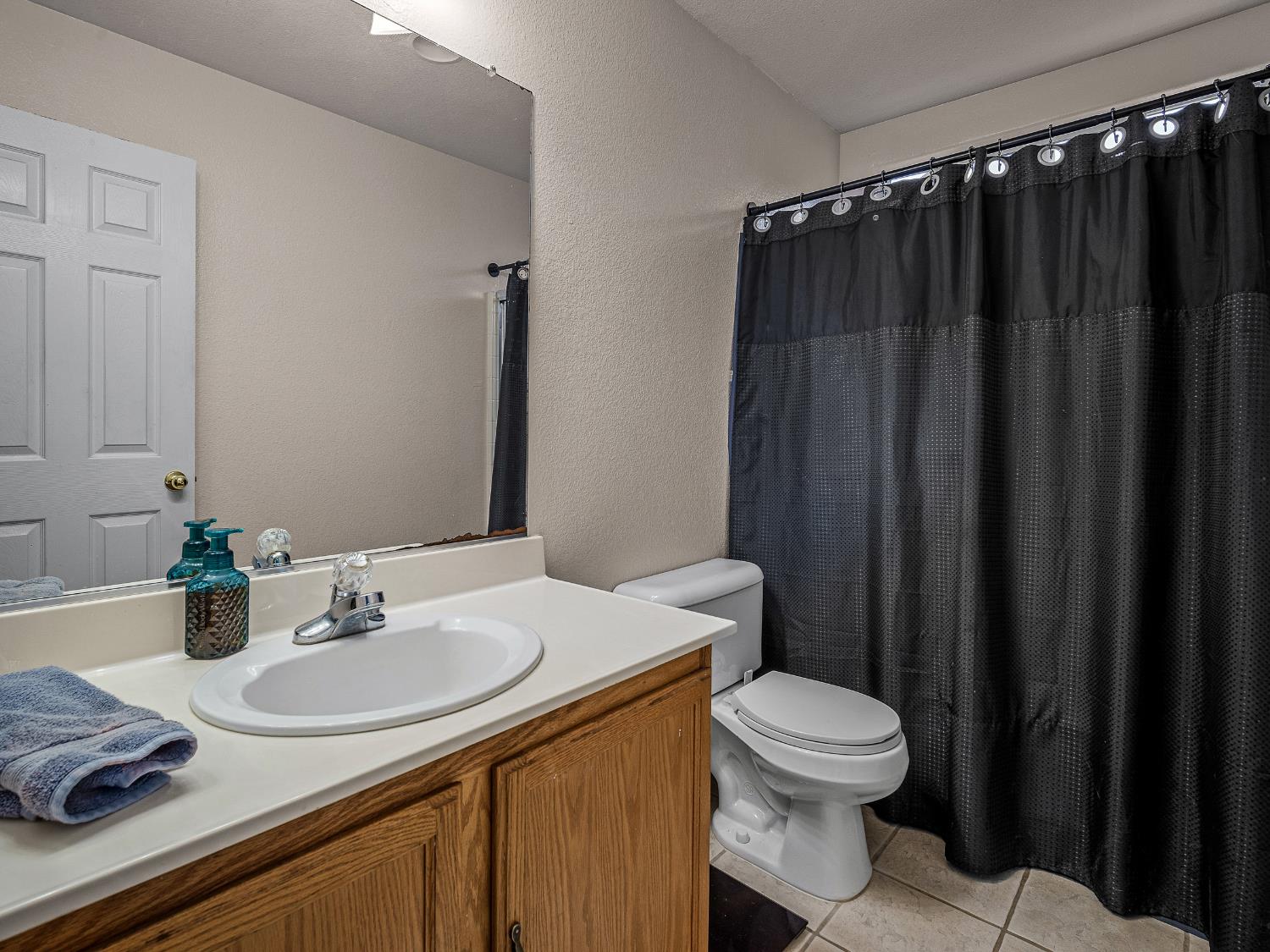 10893 Woolwich Way Mather, CA 95655 - Photo 16 of 24 a bathroom with a sink and a mirror