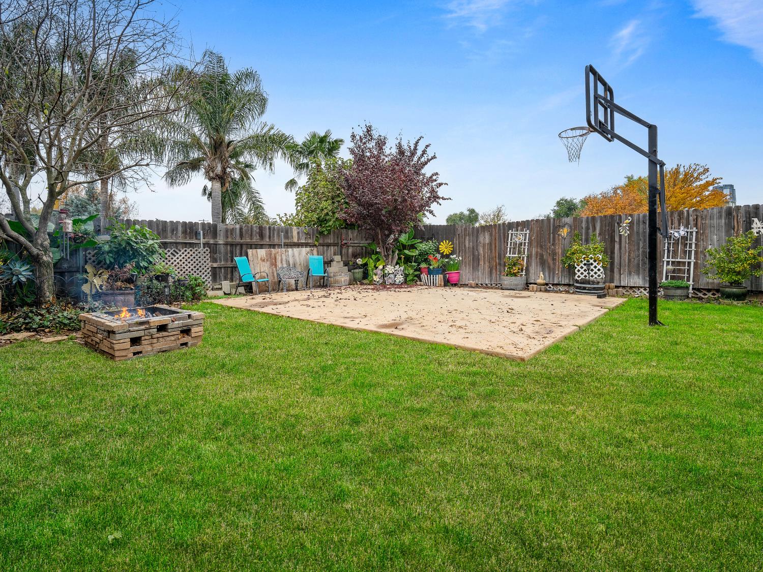 10893 Woolwich Way Mather, CA 95655 - Photo 18 of 24 a row of palm trees and a fire pit in the middle of a park