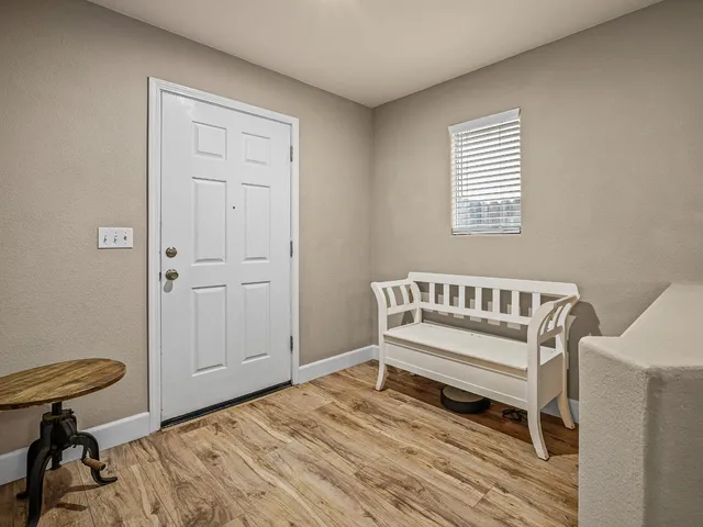 a view of a room with wooden floor and a window