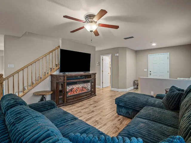a living room with furniture flat screen tv and a fireplace