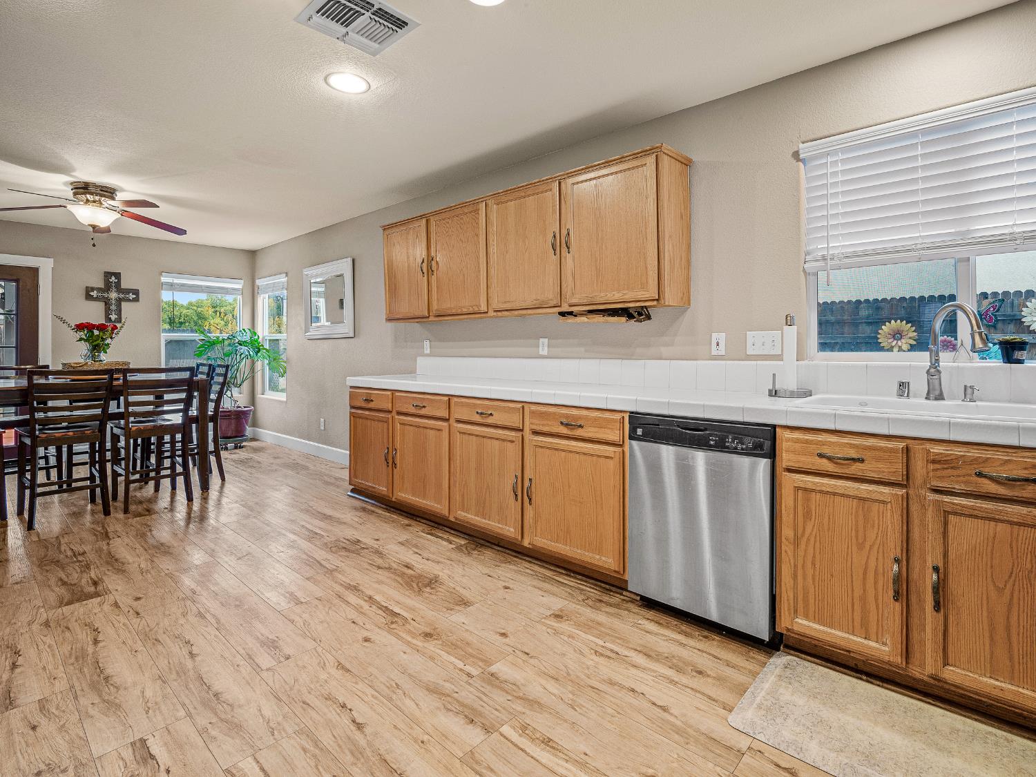 10893 Woolwich Way Mather, CA 95655 - Photo 7 of 24 a kitchen with stainless steel appliances granite countertop wooden cabinets a dining table and chairs