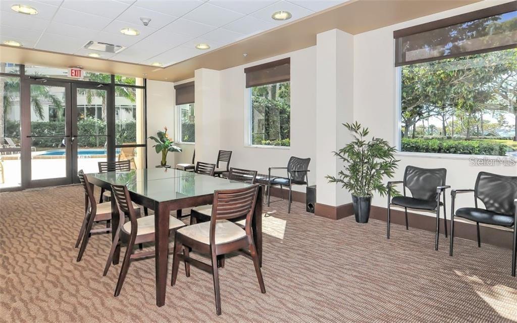 435 South Gulfstream Avenue, Unit 702 Sarasota, FL 34236 - Photo 14 of 23 a view of a dining room with furniture window and wooden floor