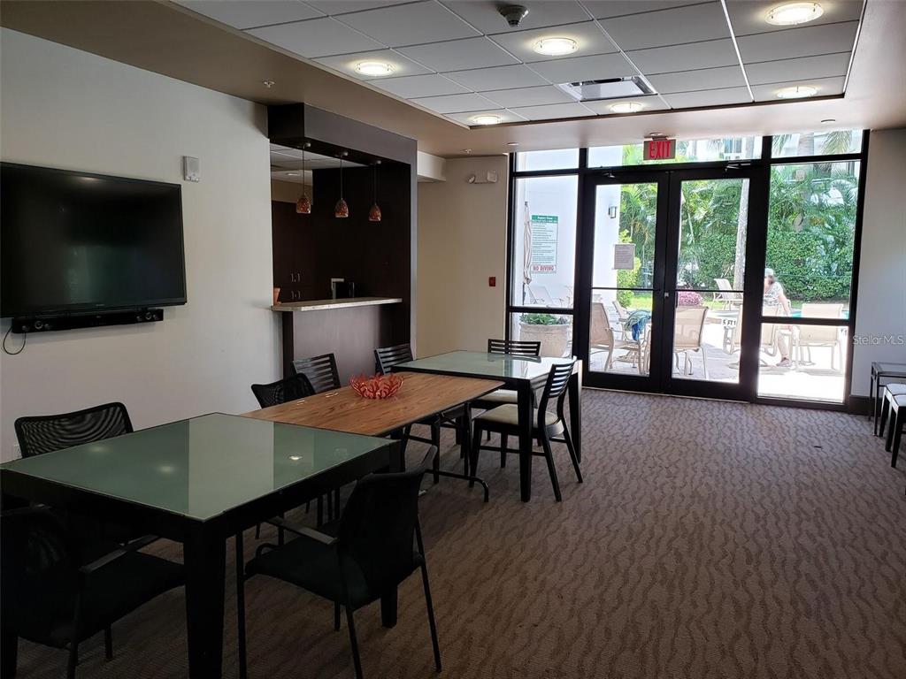 435 South Gulfstream Avenue, Unit 702 Sarasota, FL 34236 - Photo 17 of 23 a view of a dining room with furniture and wooden floor