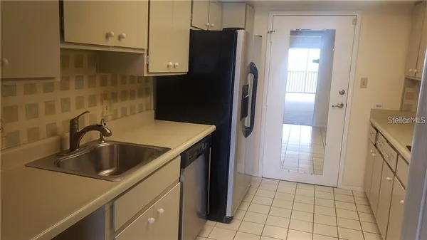 a kitchen with a sink and a refrigerator