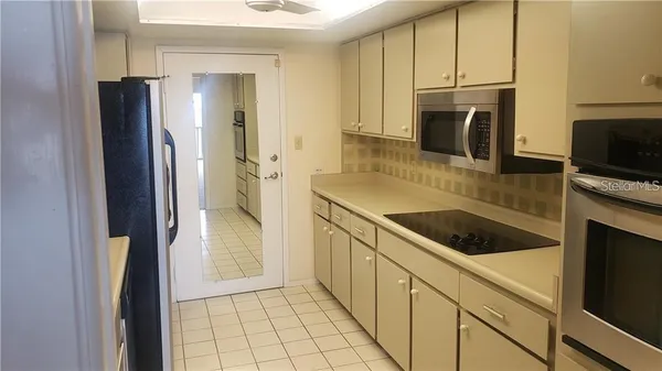 a kitchen with a refrigerator sink and microwave