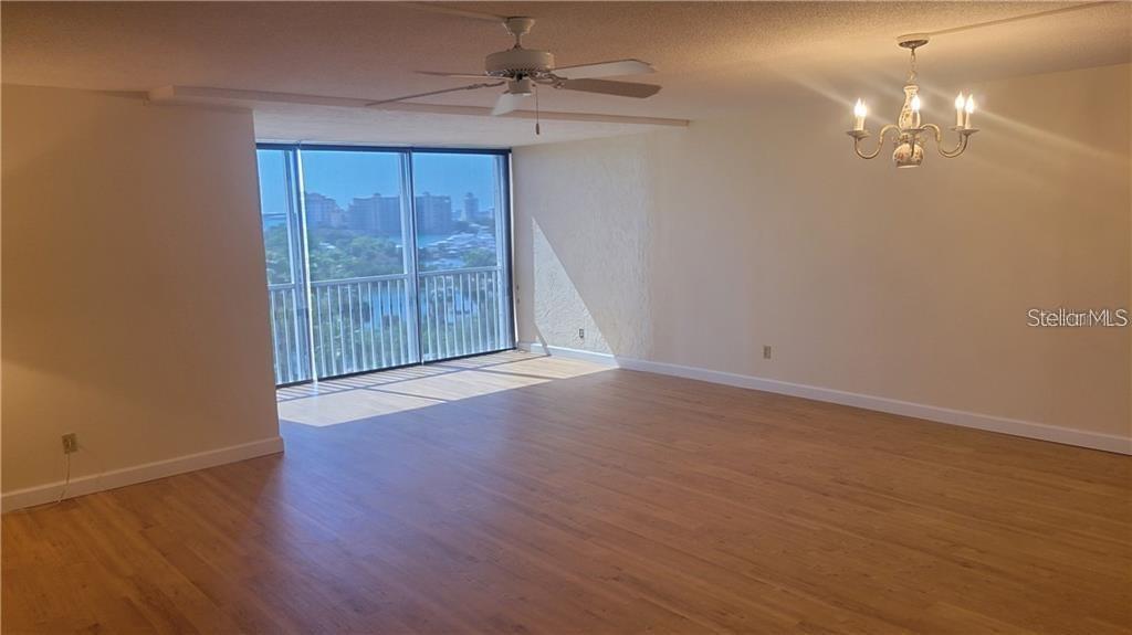 435 South Gulfstream Avenue, Unit 702 Sarasota, FL 34236 - Photo 8 of 23 wooden floor in an empty room with a window