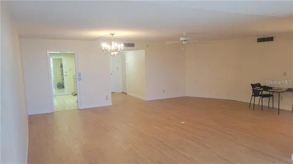 a view of a livingroom with a dinning table and chair in a room