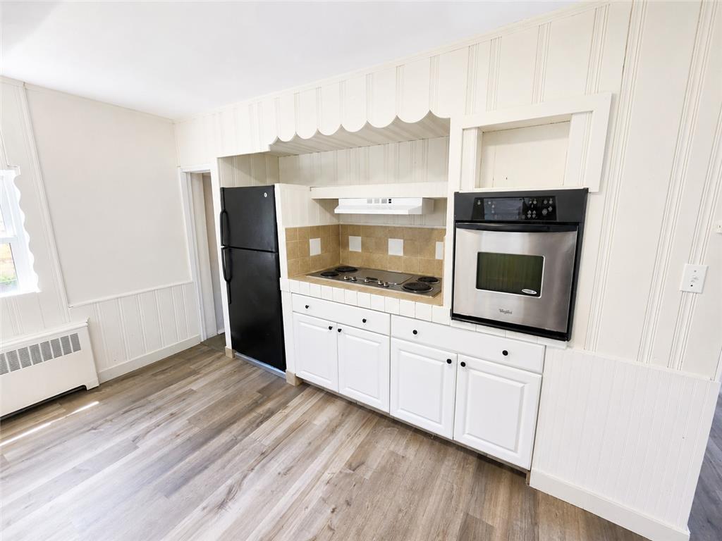 508 Riegel Street Bethlehem, PA 18018 - Photo 2 of 9 A compact kitchen with an electric cooktop and built-in oven offers practical culinary space.