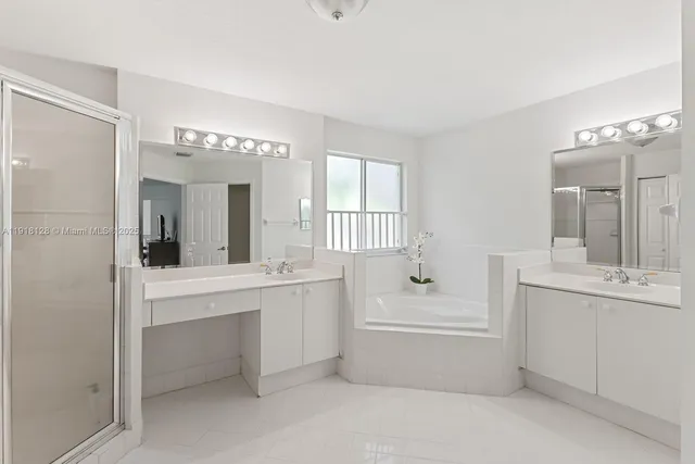 a bathroom with a tub sink and mirror