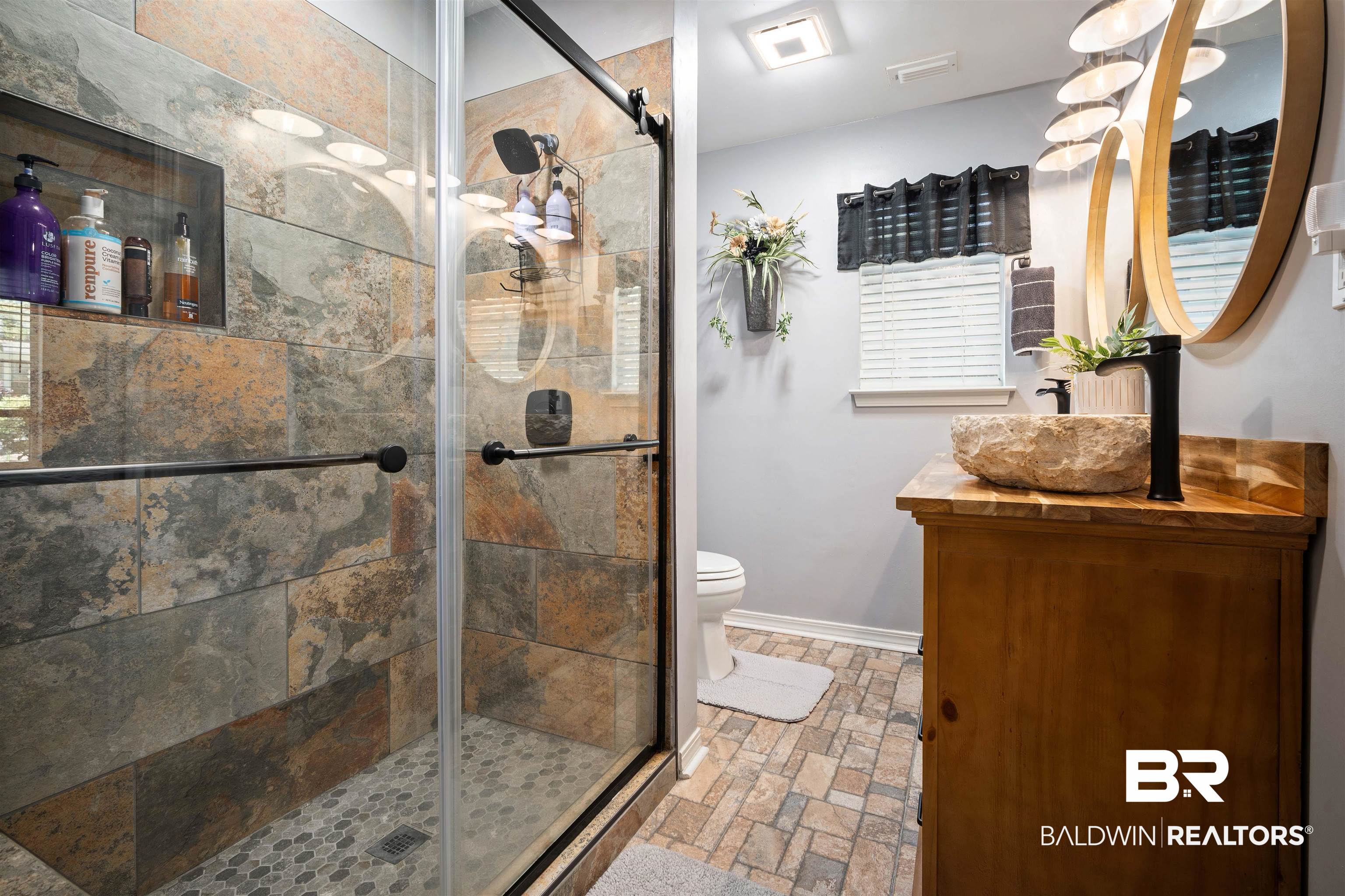 110 Lakeview Loop Daphne, AL 36526 - Photo 19 of 40 Bathroom featuring a shower stall, vanity, visible vents, toilet, and baseboards
