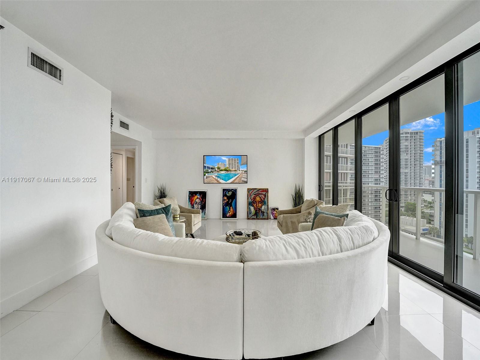 20281 East Country Club Drive, Unit 1114 Aventura, FL 33180 - Photo 12 of 87 a living room with furniture and a large window