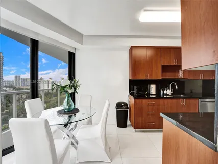 a kitchen with stainless steel appliances granite countertop a refrigerator a stove top oven a sink and dishwasher