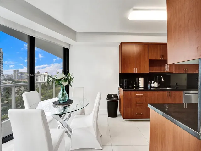 a kitchen with stainless steel appliances granite countertop a refrigerator a stove top oven a sink and dishwasher