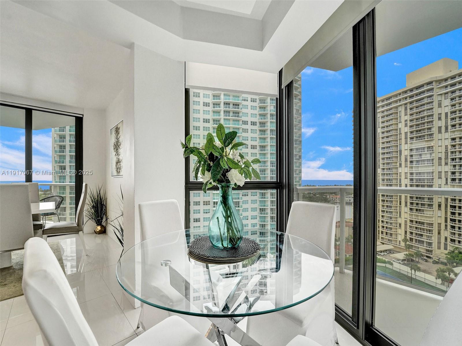 20281 East Country Club Drive, Unit 1114 Aventura, FL 33180 - Photo 23 of 87 a view of a dining room with furniture a livingroom and chandelier