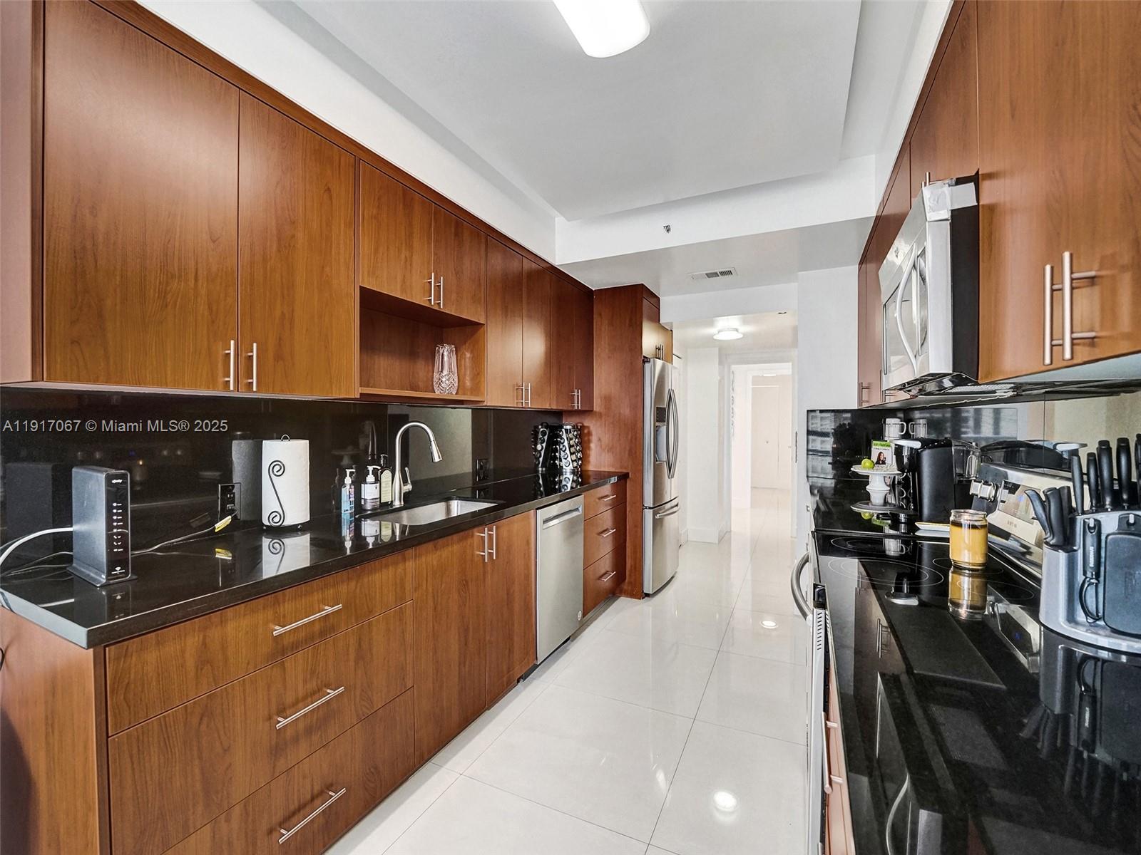 20281 East Country Club Drive, Unit 1114 Aventura, FL 33180 - Photo 25 of 87 a kitchen with stainless steel appliances granite countertop a refrigerator a stove top oven a sink and dishwasher
