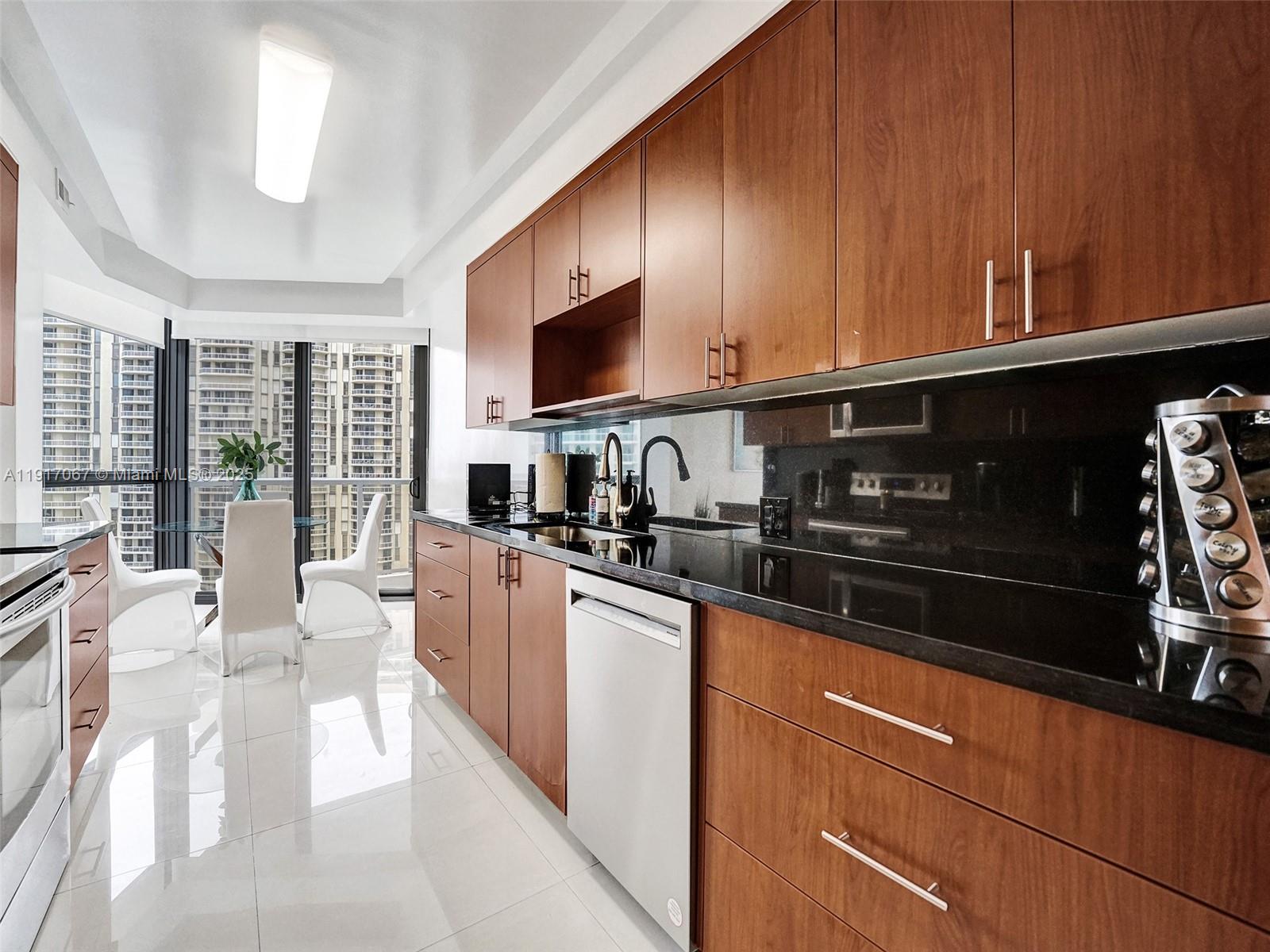 20281 East Country Club Drive, Unit 1114 Aventura, FL 33180 - Photo 30 of 87 a kitchen with stainless steel appliances granite countertop a refrigerator a stove top oven a sink dishwasher and cabinets with wooden floor