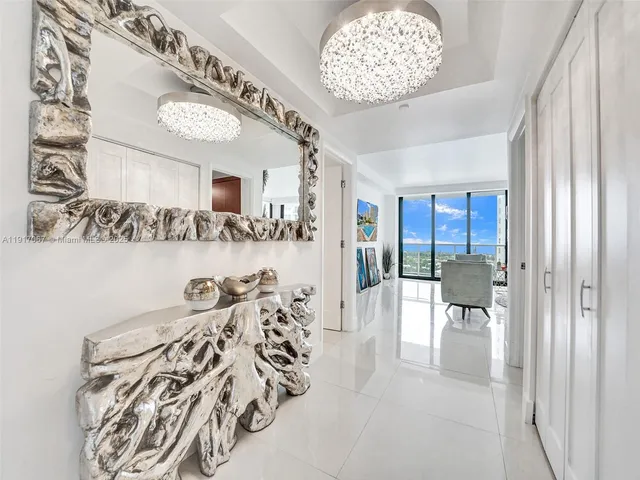 a view of a livingroom with furniture and a chandelier