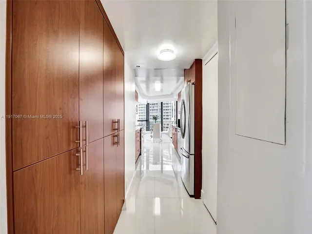 a view of walk in closet with clothes