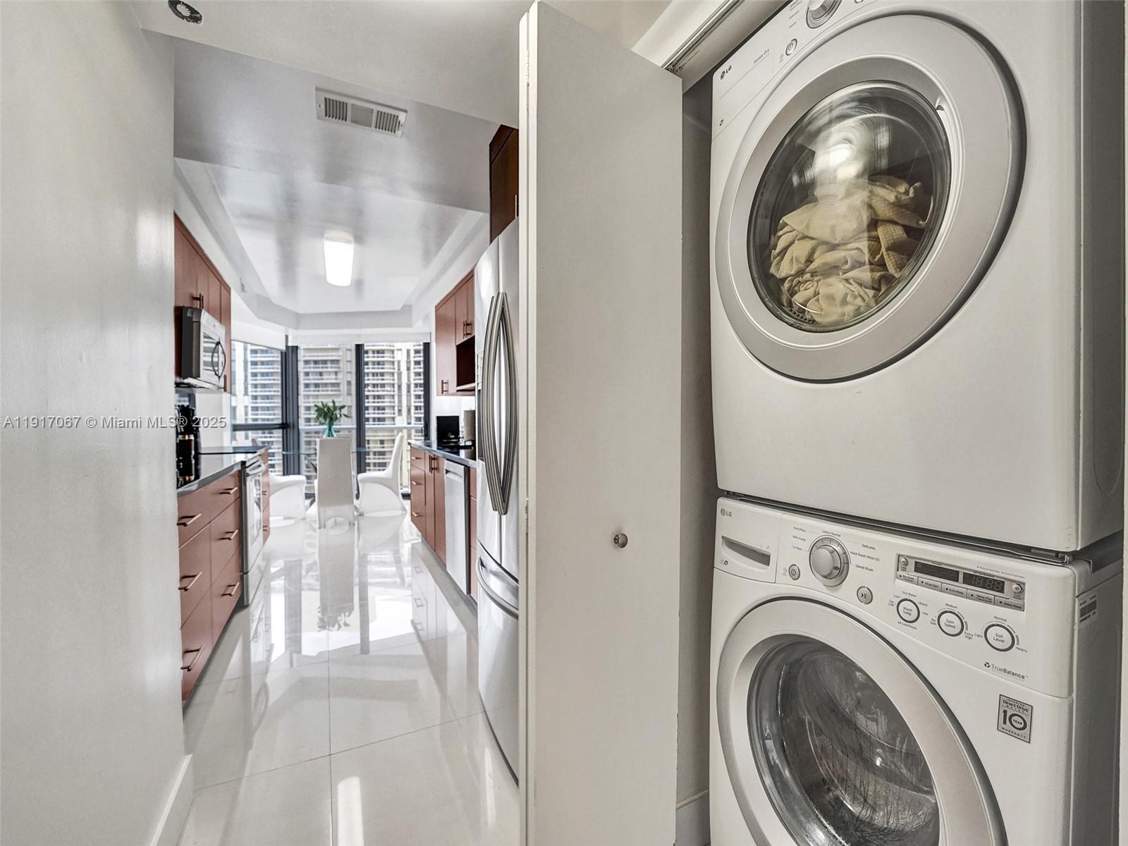 20281 East Country Club Drive, Unit 1114 Aventura, FL 33180 - Photo 33 of 87 a view of a hallway with washer and dryer