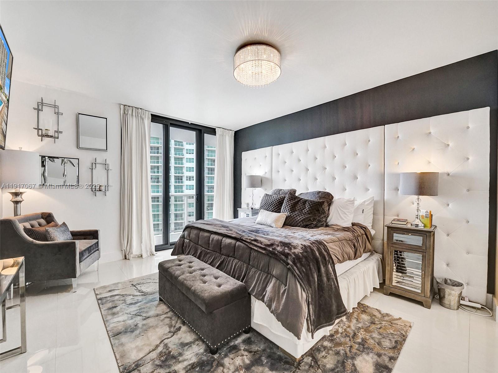 20281 East Country Club Drive, Unit 1114 Aventura, FL 33180 - Photo 36 of 87 a bedroom with a bed and a chandelier