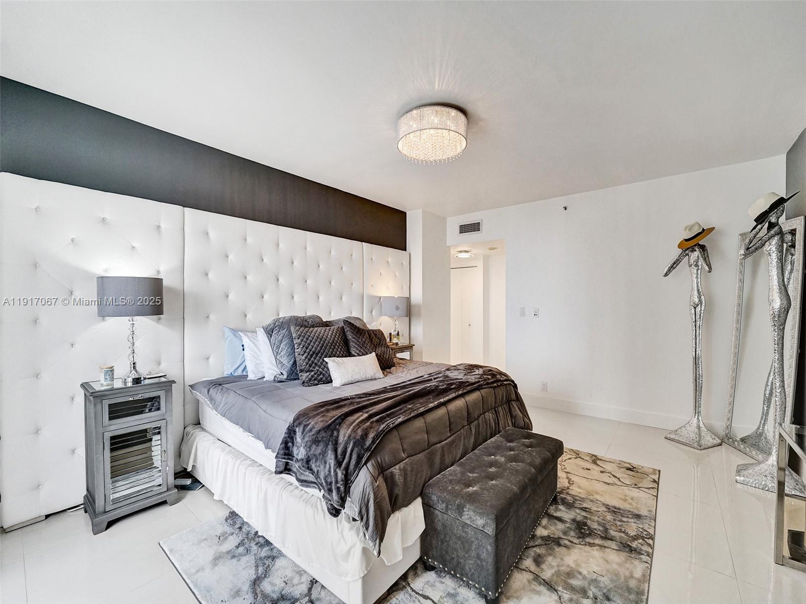 20281 East Country Club Drive, Unit 1114 Aventura, FL 33180 - Photo 38 of 87 a bedroom with a bed and a large mirror