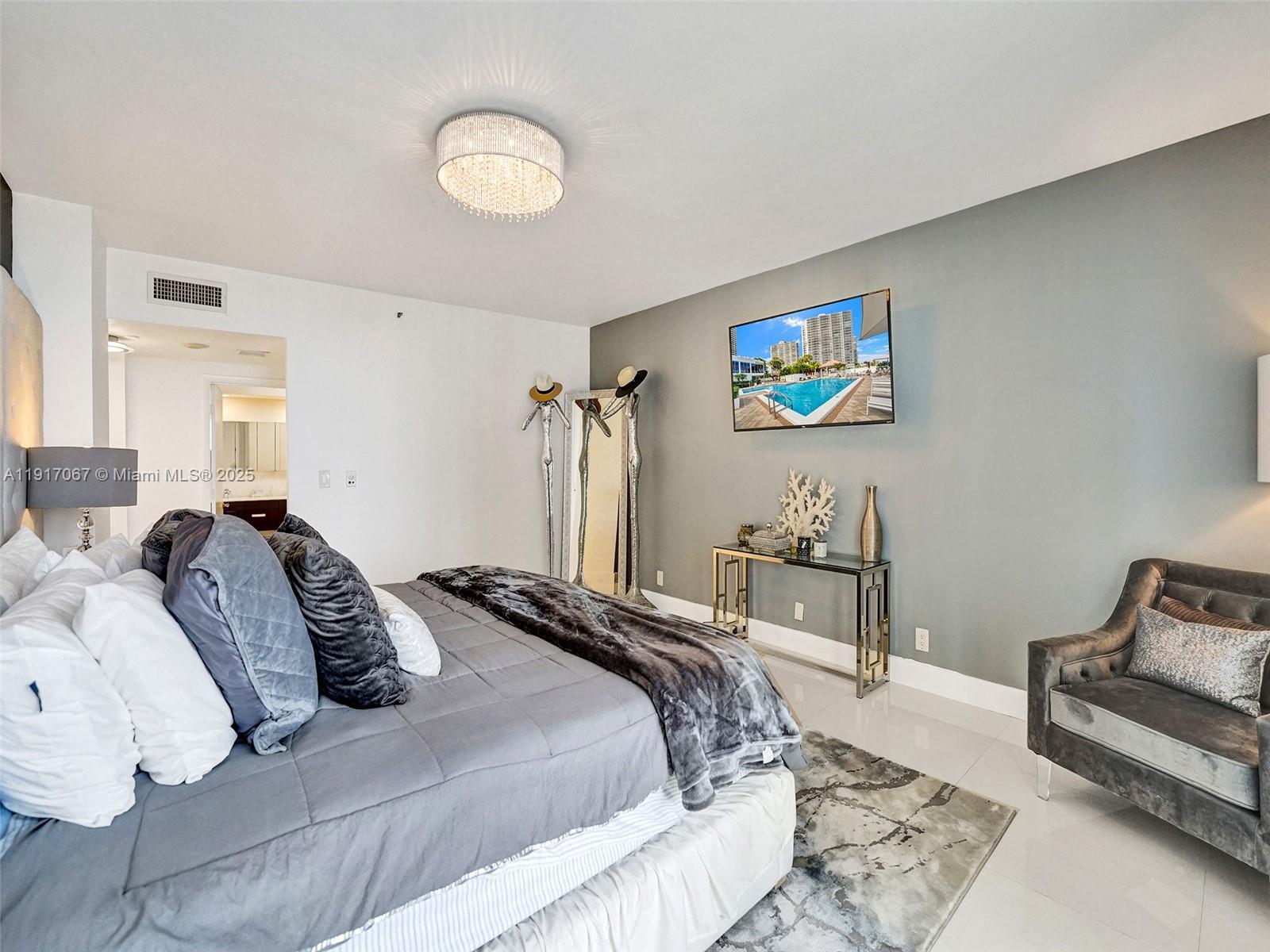 20281 East Country Club Drive, Unit 1114 Aventura, FL 33180 - Photo 39 of 87 a bedroom with bed and a couch