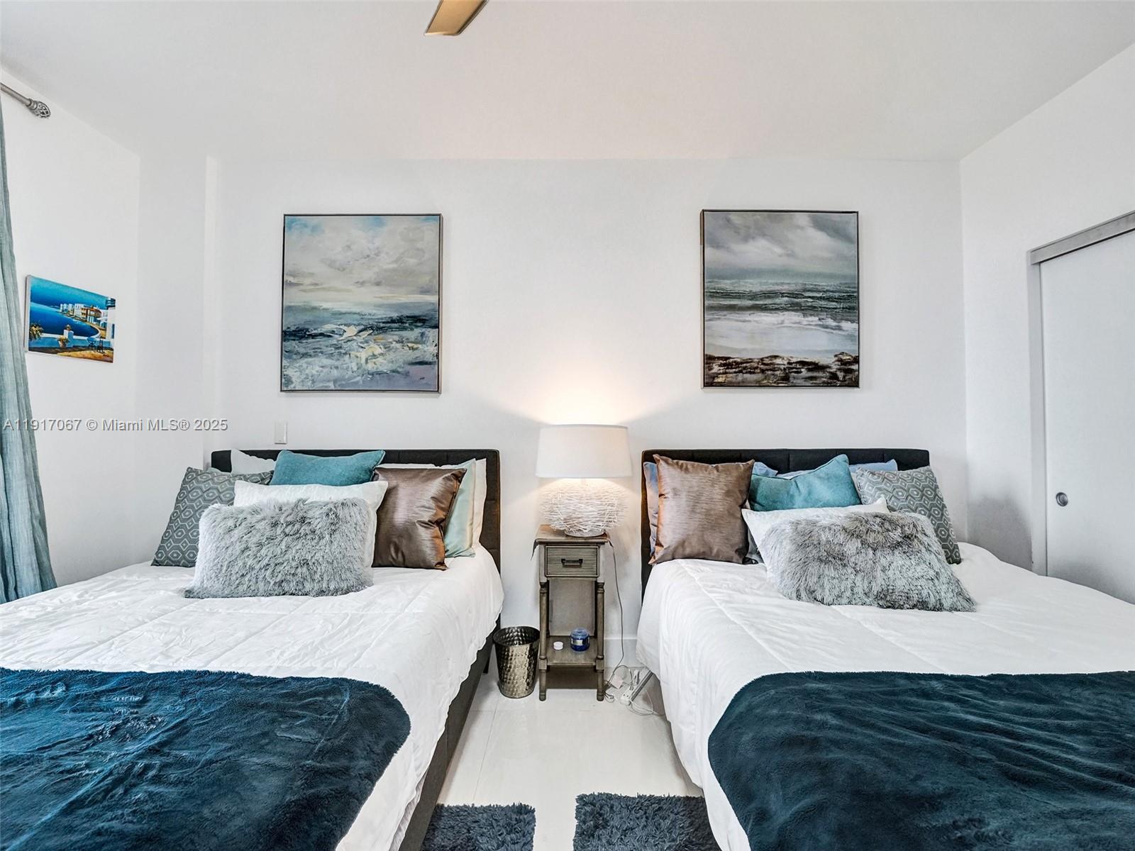 20281 East Country Club Drive, Unit 1114 Aventura, FL 33180 - Photo 47 of 87 a bedroom with two beds and painting on the wall