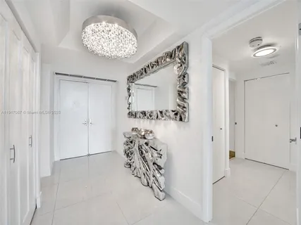 a view of entryway with livingroom and chandelier