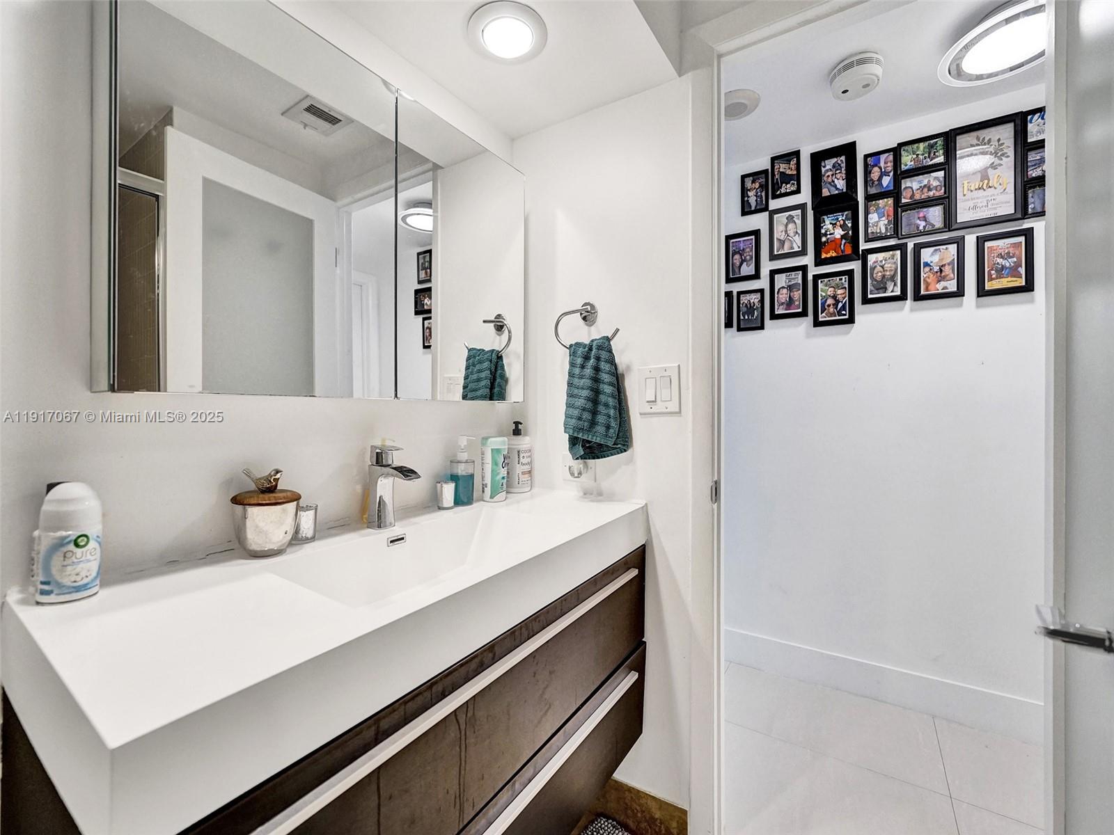 20281 East Country Club Drive, Unit 1114 Aventura, FL 33180 - Photo 53 of 87 a bathroom with a sink and a mirror