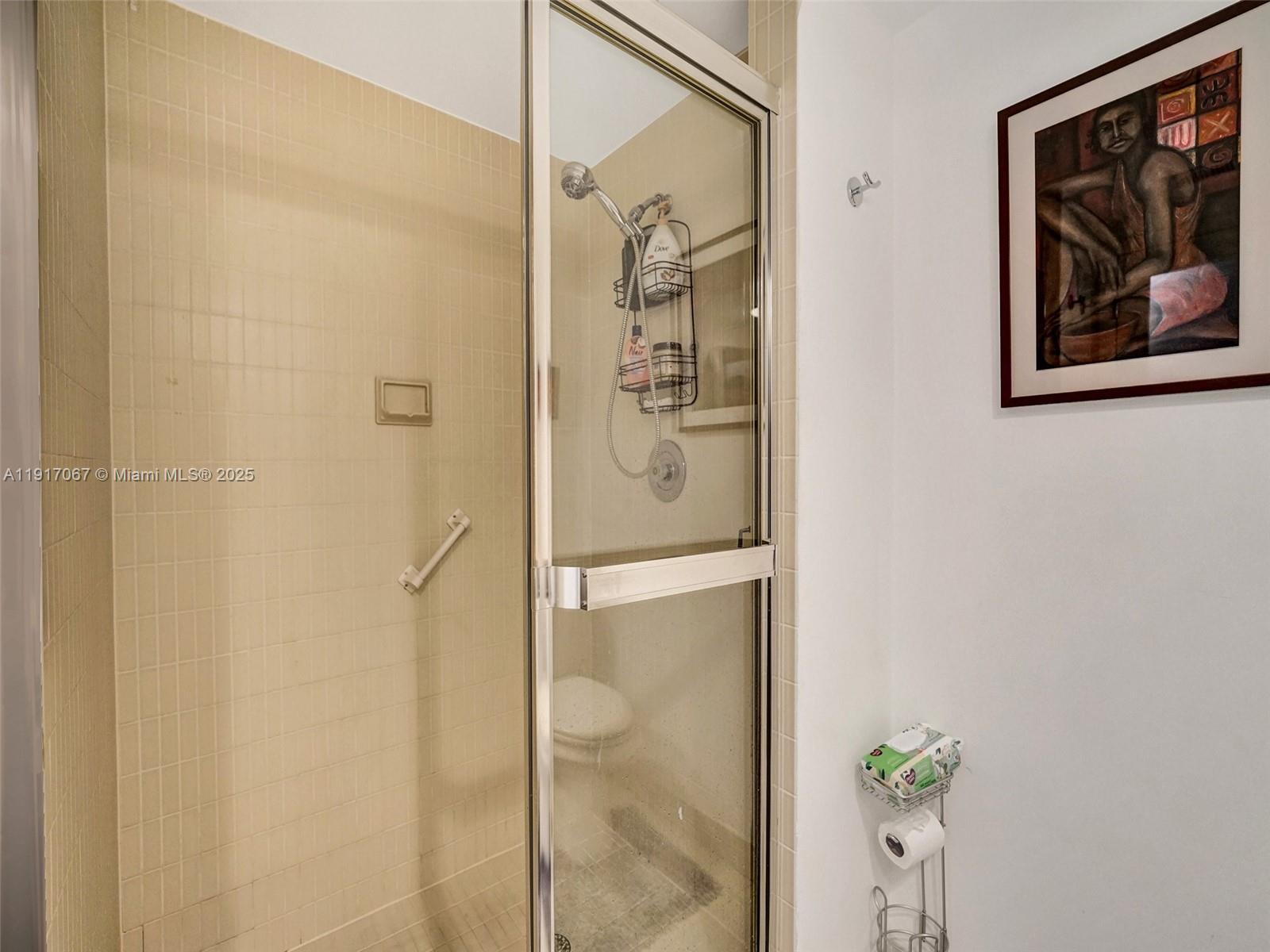 20281 East Country Club Drive, Unit 1114 Aventura, FL 33180 - Photo 54 of 87 a bathroom with a shower and a glass door