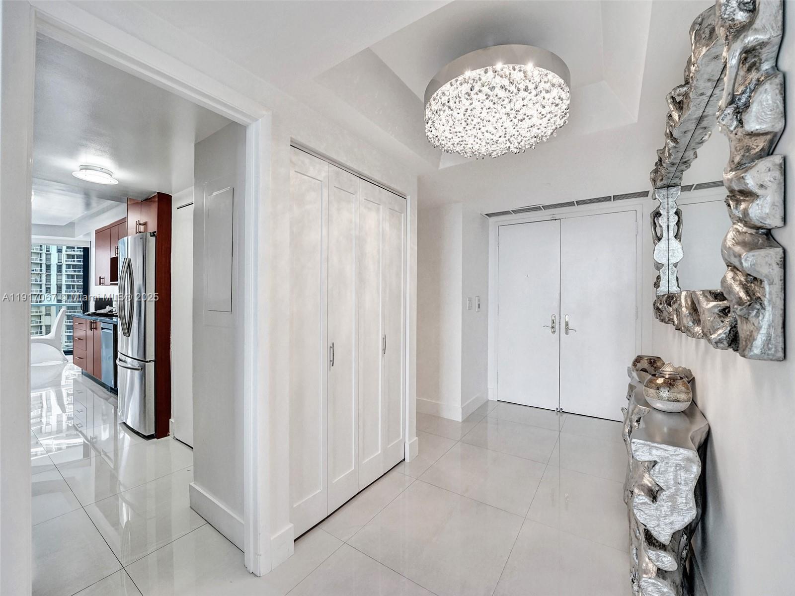 20281 East Country Club Drive, Unit 1114 Aventura, FL 33180 - Photo 6 of 87 a view of entryway with livingroom and chandelier