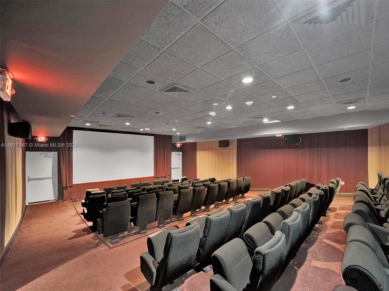 20281 East Country Club Drive, Unit 1114 Aventura, FL 33180 - Photo 61 of 87 a media room with lots of chairs and a projector screen
