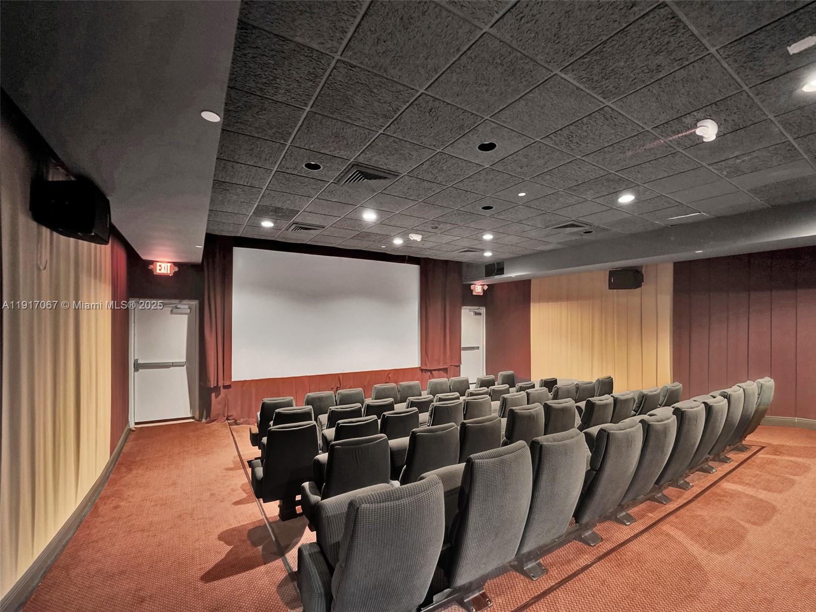20281 East Country Club Drive, Unit 1114 Aventura, FL 33180 - Photo 62 of 87 a media room with lots of chairs and a projector screen
