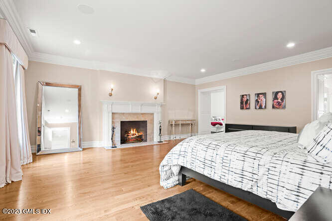 33 Boulder Brook Road Greenwich, CT 06830 - Photo 21 of 50 a bedroom with a large bed and a fireplace