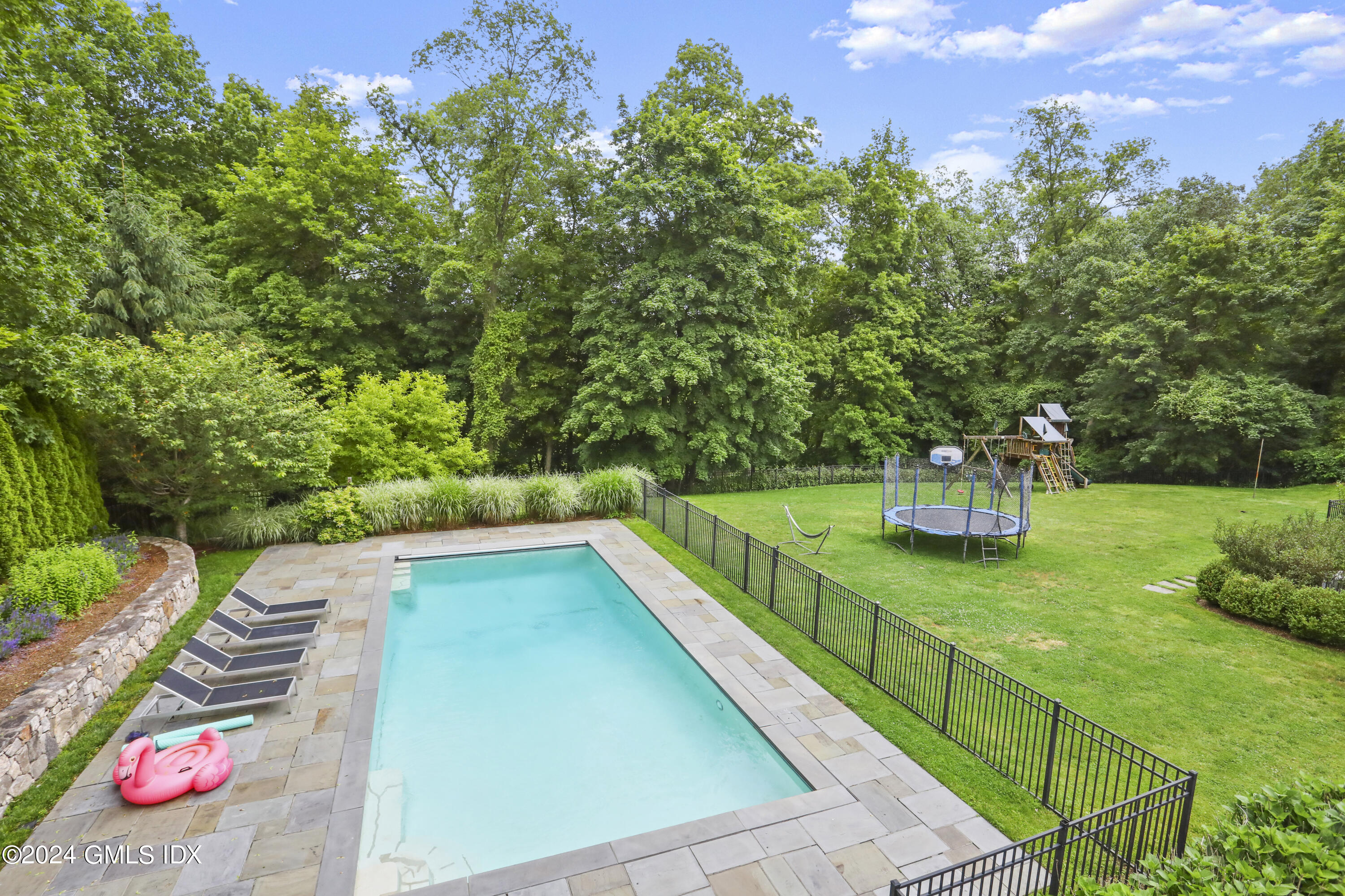 33 Boulder Brook Road Greenwich, CT 06830 - Photo 3 of 50 a view of a swimming pool with a patio