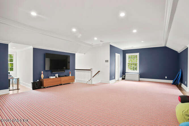 33 Boulder Brook Road Greenwich, CT 06830 - Photo 34 of 50 a bedroom with a bed and a flat screen tv