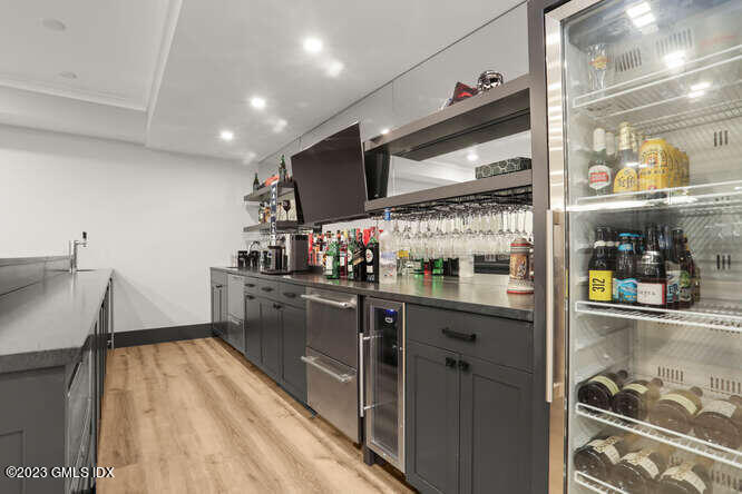 33 Boulder Brook Road Greenwich, CT 06830 - Photo 40 of 50 a kitchen with stainless steel appliances granite countertop a sink and wooden cabinets