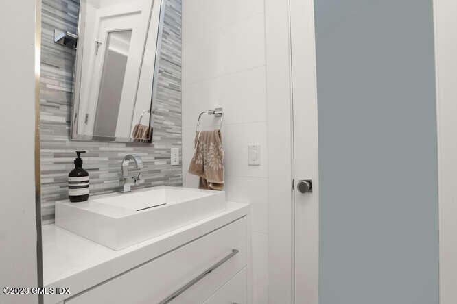 33 Boulder Brook Road Greenwich, CT 06830 - Photo 44 of 50 a bathroom with a sink and a mirror