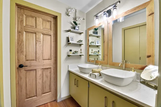 a bathroom with a sink double vanity and a mirror