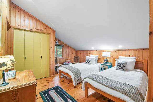 a bedroom with two beds and a dresser