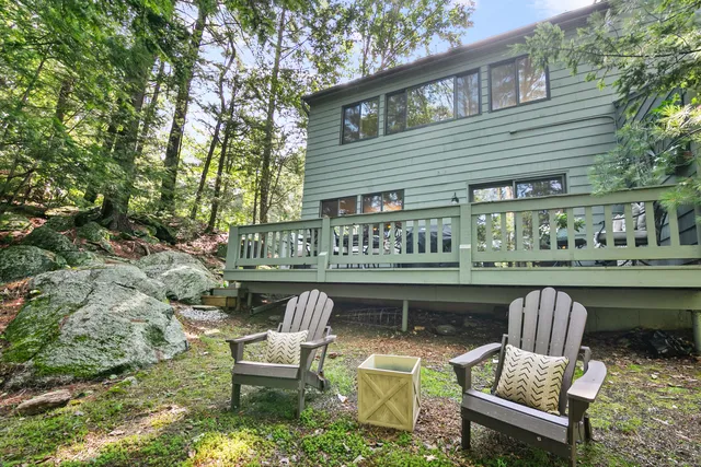 a wooden bench sitting in front of a house