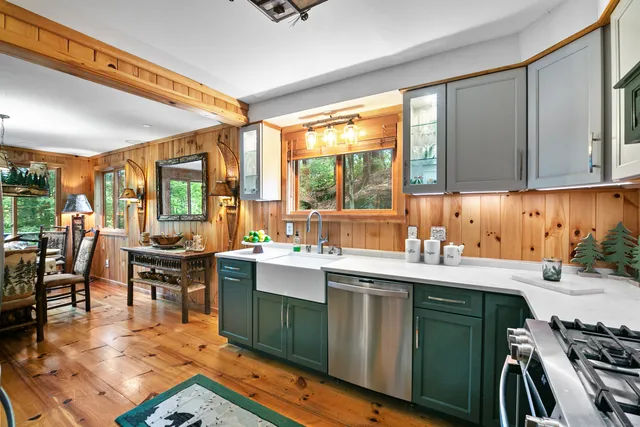 a kitchen with a sink stove and cabinets