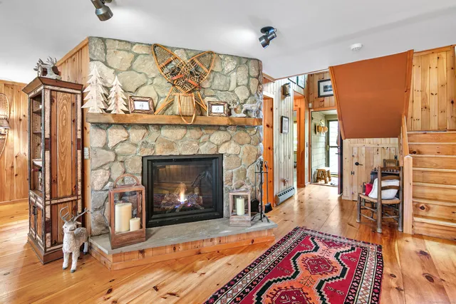 a living room with furniture a fireplace and a table