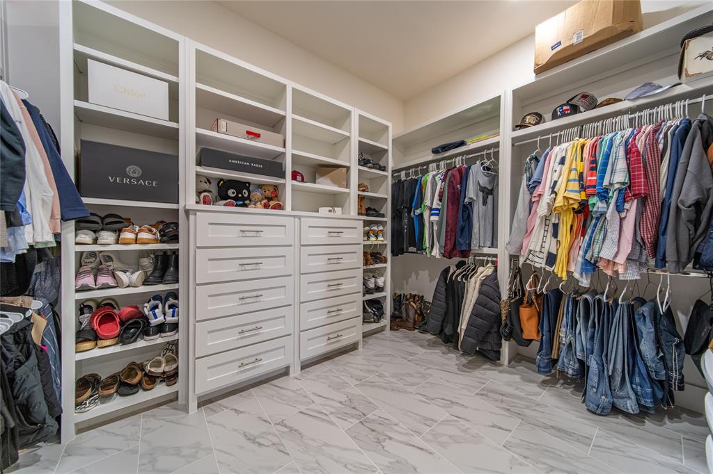 165 Ranch House Road Rockwall, TX 75032 - Photo 29 of 40 a view of walk in closet with clothes and shoes