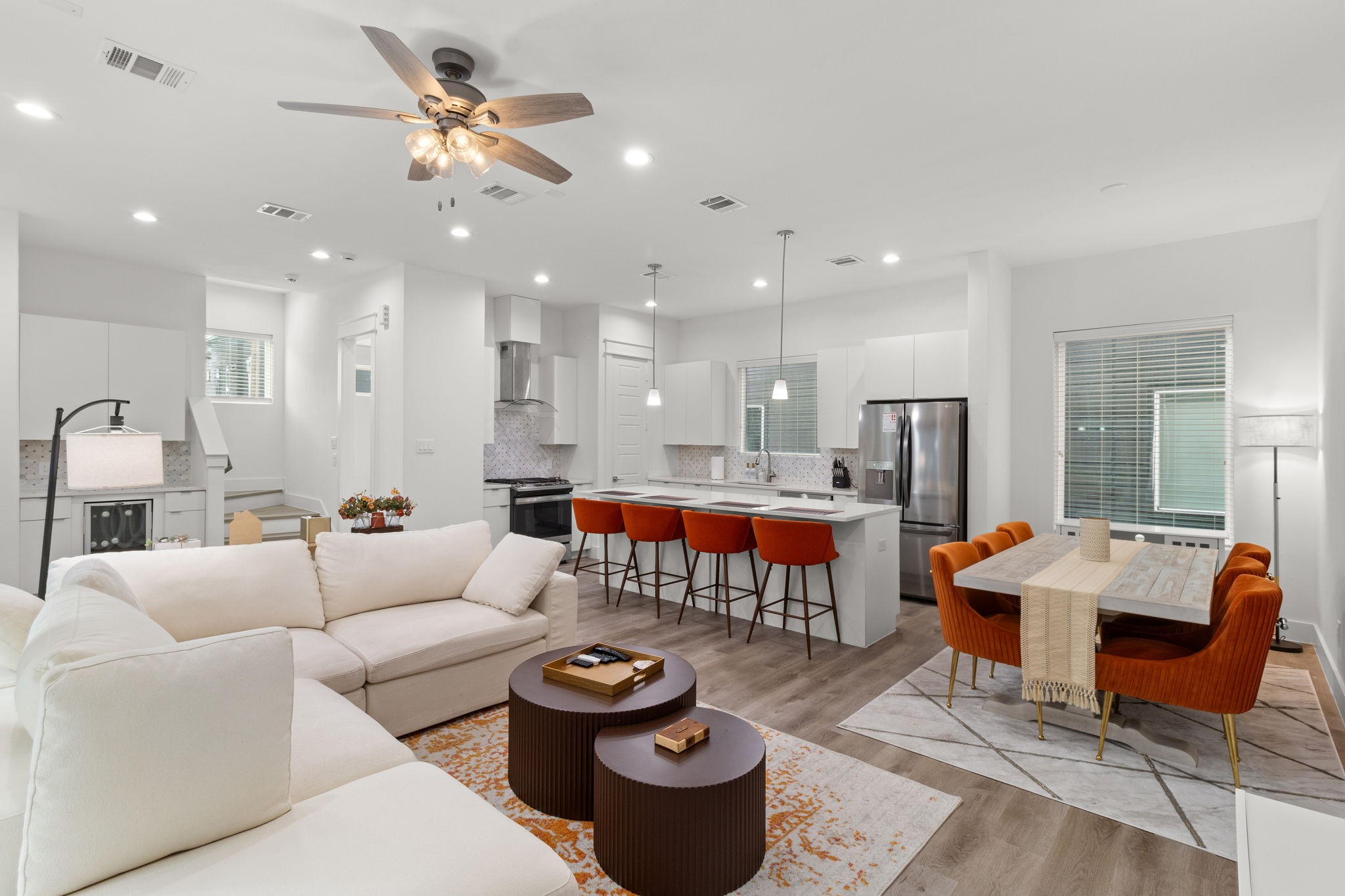 a living room with furniture and kitchen view