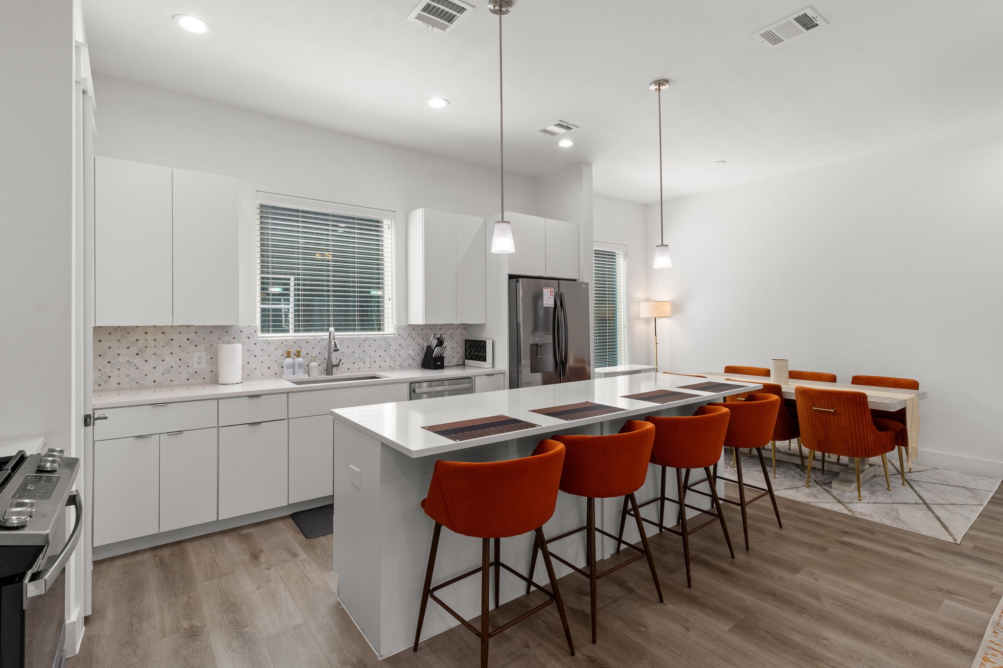 517 Schweikhardt Street Houston, TX 77020 - Photo 11 of 49 a kitchen with a sink a stove a dining table and chairs
