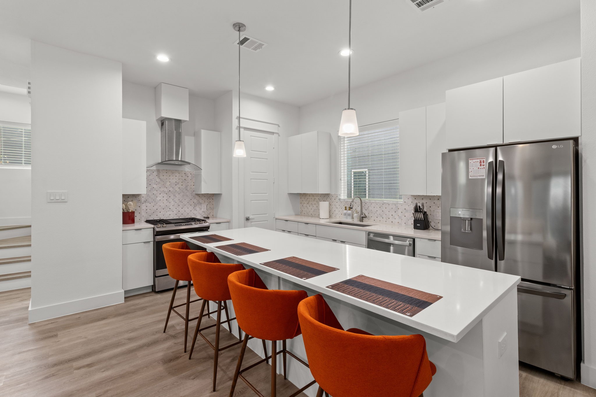 517 Schweikhardt Street Houston, TX 77020 - Photo 9 of 49 a kitchen with stainless steel appliances granite countertop a refrigerator a sink a stove a dining table and chairs