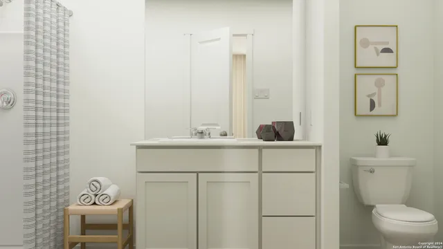 a bathroom with a sink vanity granite toilet and a mirror